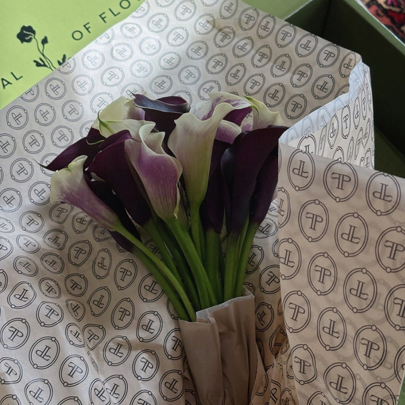 Purple and white calla lilies unwrapped from Floral Post monogram paper